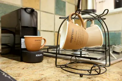 a kitchen counter with two mugs and a coffee cup at Imperial Forum House in Rome