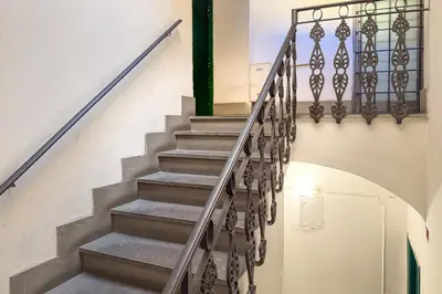 a staircase in a building with a metal railing at Imperial Forum House in Rome
