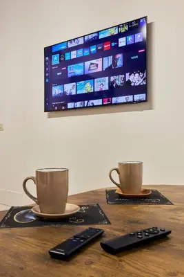 two coffee cups and remote controls sitting on a table at Imperial Forum House in Rome