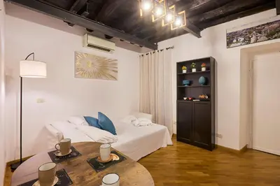 a bedroom with a bed and a table in a room at Imperial Forum House in Rome