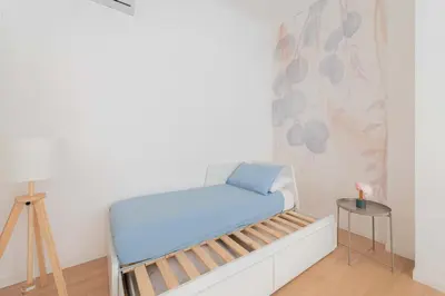 a small room with a bed and a table at ZanzurMiddleHouse Apartment in Rome
