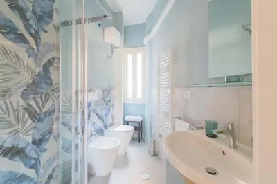 a bathroom with a tub and a toilet and a sink at ZanzurMiddleHouse Apartment in Rome
