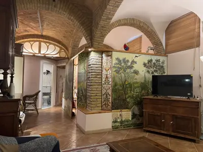 a living room with a large painting on the wall at DOMUS DIANE MONTI Apartment in Rome
