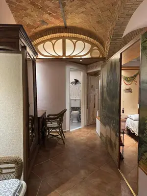 a hallway with a table and a ceiling at DOMUS DIANE MONTI Apartment in Rome