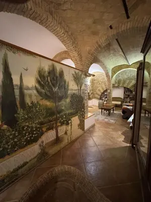 a room with a painting of trees on the wall at DOMUS DIANE MONTI Apartment in Rome