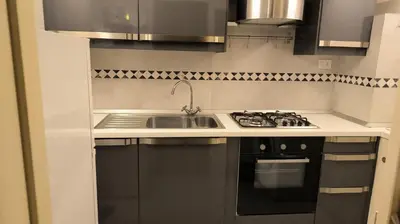 a kitchen with a sink and a stove at DOMUS DIANE MONTI Apartment in Rome