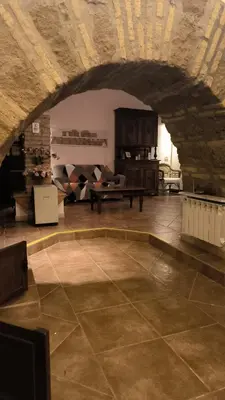 a living room with a stone floor and a table at DOMUS DIANE MONTI Apartment in Rome