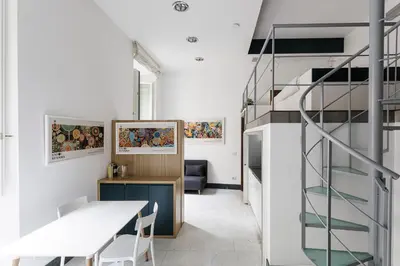 a staircase in a room with a table and a stair case at Casina Albani in Rome