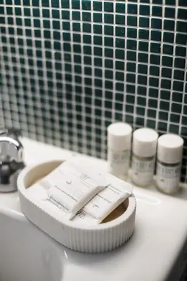a white container of medicines sitting on a bathroom sink at Casina Albani in Rome