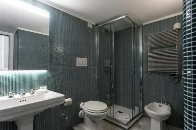 a bathroom with a toilet and a sink and a shower at Casina Albani in Rome