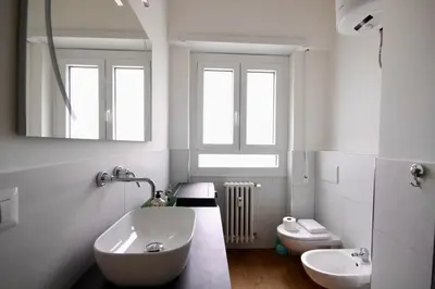 a white bathroom with a sink and a toilet at HC - Charming Apartment in Vigna Clara in Rome
