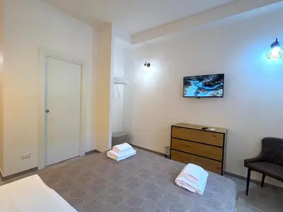 a bedroom with a bed and a chair and a dresser at Casa della Musica - Guesthouse in Rome