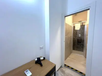 a bathroom with a mirror and a phone on a desk at Casa della Musica - Guesthouse in Rome