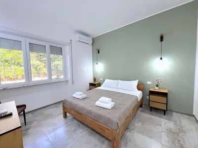 a bedroom with a bed with two towels on it at Casa della Musica - Guesthouse in Rome