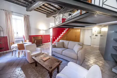 a living room with a couch and a table at The Scarlet Loft in Trastevere in Rome