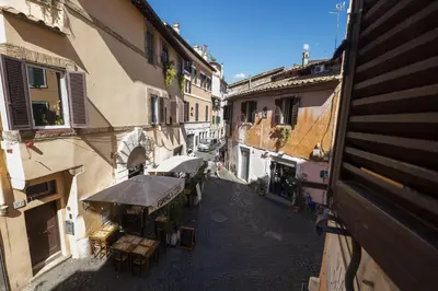an overhead view of an alley with tables and umbrellas at The Scarlet Loft in Trastevere in Rome