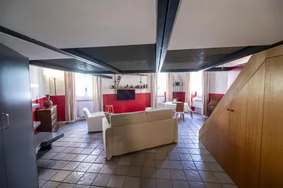 a living room with a couch and a table at The Scarlet Loft in Trastevere in Rome