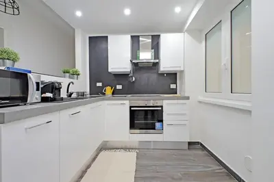 a white kitchen with a sink and a microwave at Makà, una struttura dal fascino unico in Rome