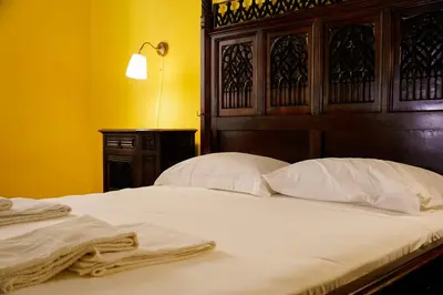 a bedroom with a bed with white sheets and pillows at Residenza Ducale in Rome