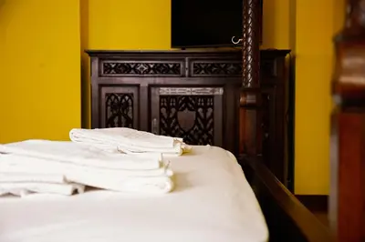 a bed with white sheets and a tv on top at Residenza Ducale in Rome
