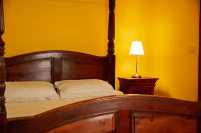 a bedroom with a wooden bed and a lamp at Residenza Ducale in Rome