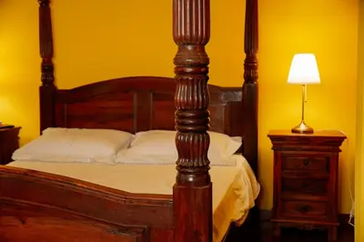 a bed with a wooden bed frame and a night stand at Residenza Ducale in Rome