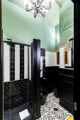a bathroom with a shower with a black and white tile at Rome As You Feel - Maison Torre Argentina - Arenula 41 in Rome