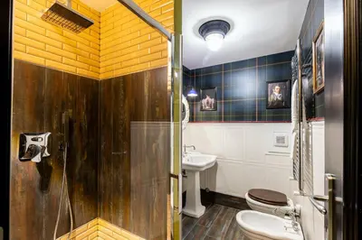 a bathroom with two toilets a sink and a shower at Rome As You Feel - Maison Torre Argentina - Arenula 41 in Rome