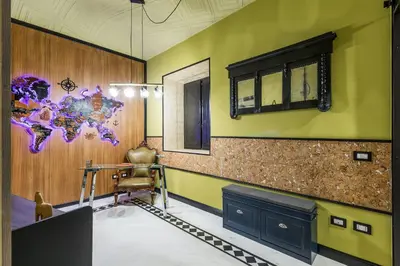 a room with a table and a chair and a wall at Rome As You Feel - Maison Torre Argentina - Arenula 41 in Rome