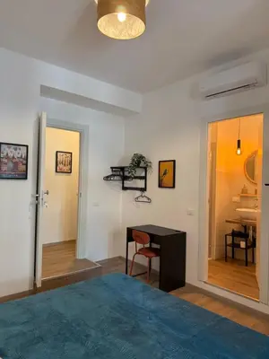 a bedroom with a bed and a desk and a table at B&B Loggia Garbatella in Rome
