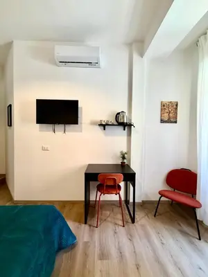a bedroom with a desk and a chair and a television at B&B Loggia Garbatella in Rome