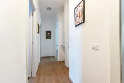 a hallway with white walls and wood floors at B&B Loggia Garbatella in Rome