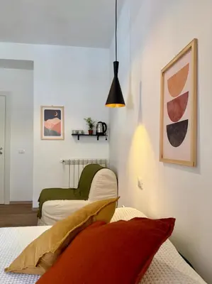 a bedroom with two beds and a pendant light at B&B Loggia Garbatella in Rome