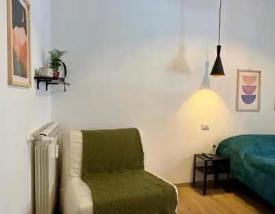 a bedroom with a chair and a bed at B&B Loggia Garbatella in Rome