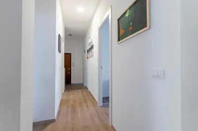 a hallway in a house with white walls and wood floors at B&B Loggia Garbatella in Rome
