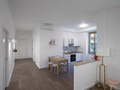 a kitchen with white walls and a table and chairs at Enjoy Rome San Paolo Retreat in Rome