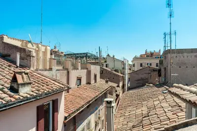 a view of roofs of buildings in a city at Renovated Luxury Sweet Penthouse - Campo Dei Fiori in Rome