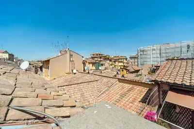 a view of roofs of a city with buildings at Renovated Luxury Sweet Penthouse - Campo Dei Fiori in Rome