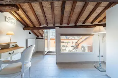 a room with a desk and a table and a window at Renovated Luxury Sweet Penthouse - Campo Dei Fiori in Rome