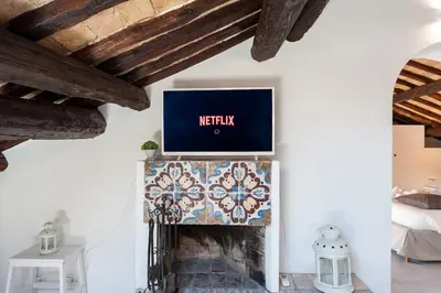 a living room with a fireplace with a tv on the wall at Renovated Luxury Sweet Penthouse - Campo Dei Fiori in Rome
