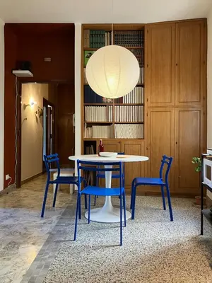 a dining room with a table and blue chairs at Casa Troccoli in Rome