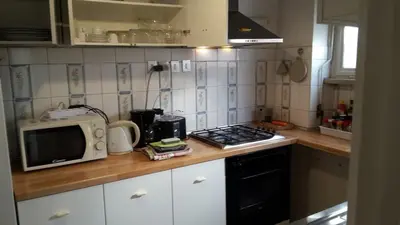 a small kitchen with a microwave and a stove at Apartment Rome Parioli near Villa Borghese in Rome