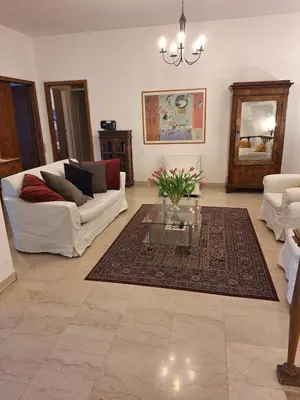 a living room with a white couch and a glass table at Apartment Rome Parioli near Villa Borghese in Rome