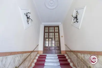 a staircase leading to a door in a building at Domus Latina heart San Giovanni in Rome