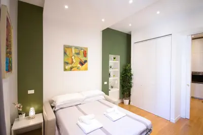 a bedroom with a bed and a green wall at Corso 277 Apartment in Rome