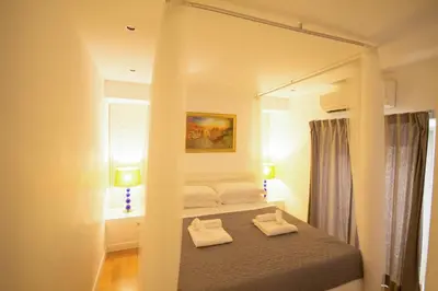 a bedroom with a bed with a large mirror at Corso 277 Apartment in Rome
