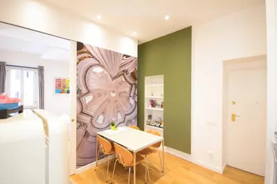 a dining room with a table and a painting on the wall at Corso 277 Apartment in Rome