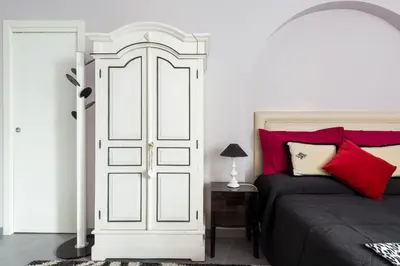 a bedroom with a bed with red pillows at Residenza Romana Zucchelli in Rome