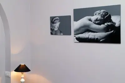 three pictures of a naked man on a wall at Residenza Romana Zucchelli in Rome