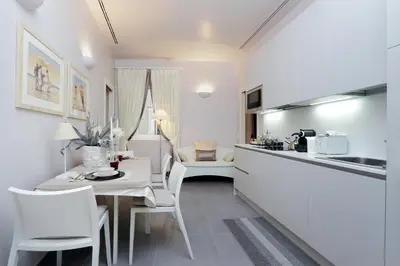 a kitchen and dining room with a table and chairs at Residenza Romana Zucchelli in Rome